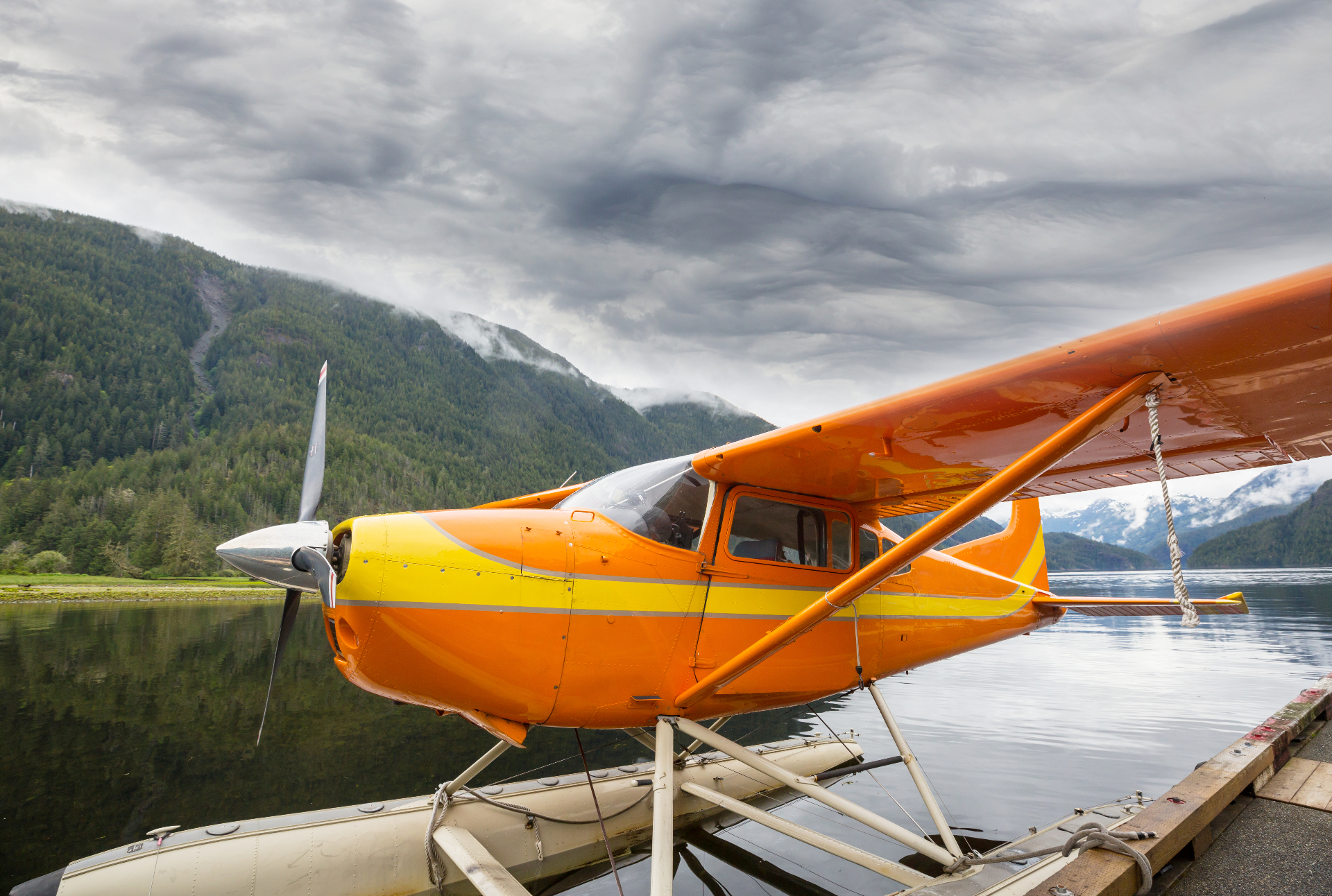 Float-equipped backcountry single docked on a mountain lake