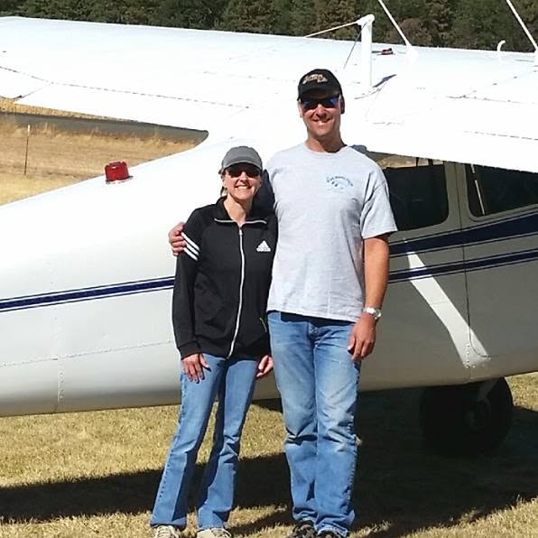 Erik and his wife next to their Cessna